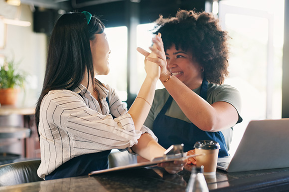 coffee shop workers giving a high-five