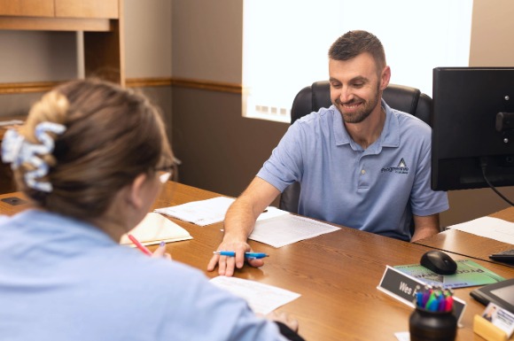 Male lender with customer signing documents