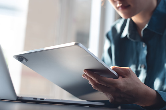close-up of a woman holding a tablet
