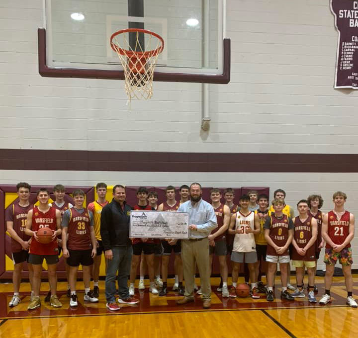 Progressive Ozark Bank staff handing large check to youth basketball team
