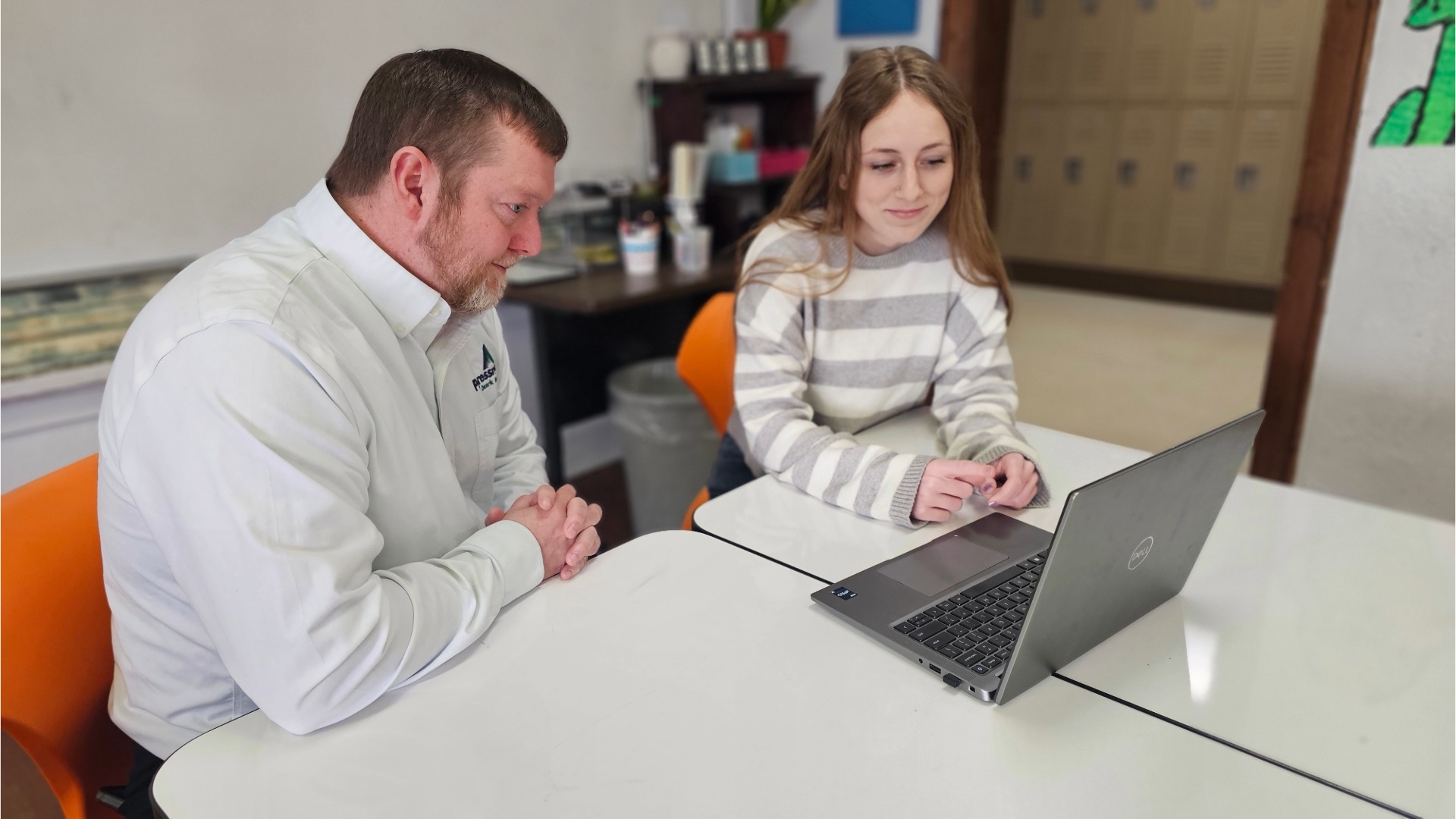 Jason Stone and Amaya King at computer reviewing her presentation