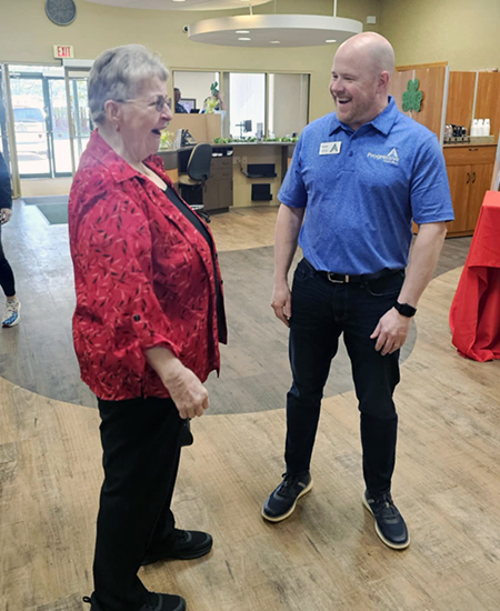 bank staff laughing with a senior woman